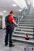 Woman cleaning stairs in a commercial building with the motorscrubber