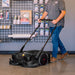 This photo depicts a pan using the Tomahawk 30" Battery Powered Push Sweeper .