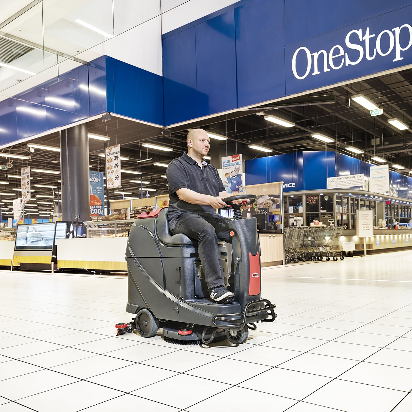 Operator using Viper AS530 R 20 In Ride On Microscrubber at a mall