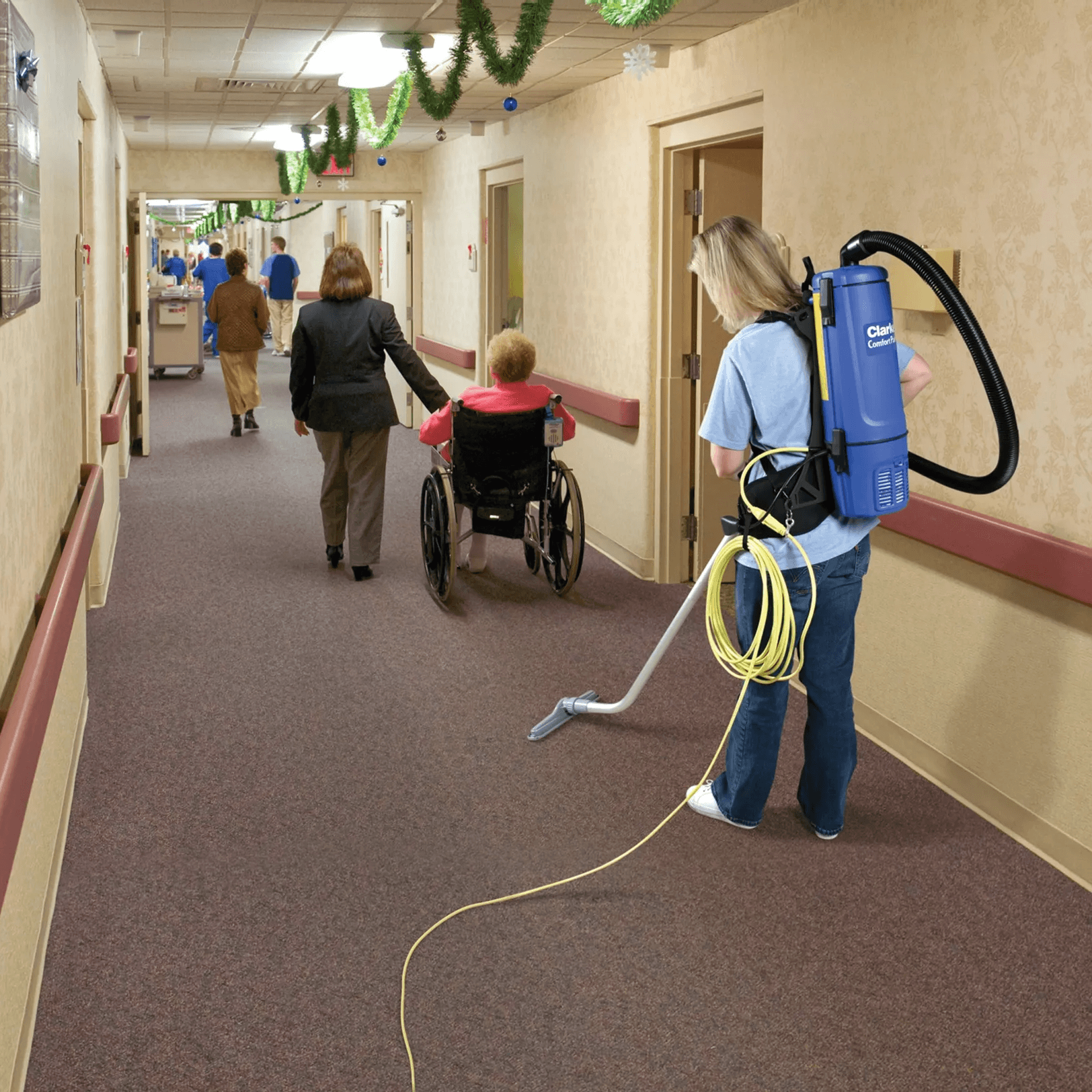 Cleaning the hallway of a nursing room with the Clarke PAK 10 Vacuum