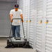 Tomahawk push sweeper for indoor use. This photo shows the Tomahawk push sweeper being used in a storage facility.